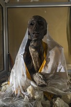 Mummy of a monk from 15th century in a glas container at a temple