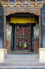 The old wooden entrance door of Matho Gompa