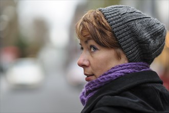 Portrait of a young woman wearing a hat and a scarf