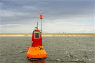 Navigable water buoy in front of a sandbank