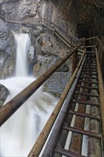 Wooden bridge and a waterfall in Baerenschuetzklamm gorge