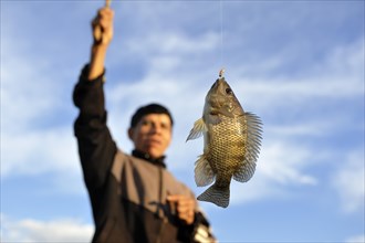 Indigenous man with a fish on the hook