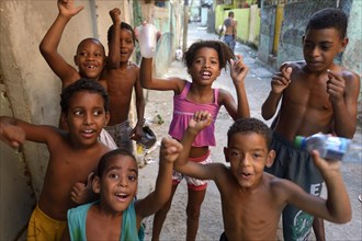 Children cheering happily in a slum or favela