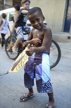 Young boy holding a kite in a slum or favela