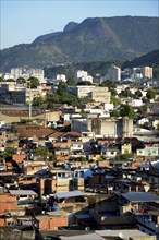 View over a slum or favela towards the high-rise apartment buildings where the urban middle class live