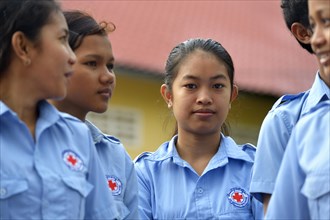 Young women wearing uniforms of the Red Cross during a training course for young people to become first aid workers by the Red Cross