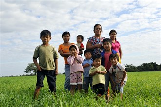 Women and children of an indigenous community of Guarani Indians in a field