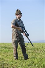 Hunter standing on a meadow