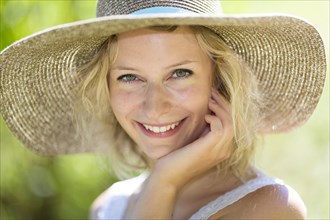 Smiling young woman with summer hat