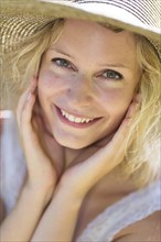 Smiling young woman with summer hat