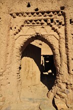 Clay stucco of a decaying entrance gate in the Kasbah Tamnougalt near Agdz