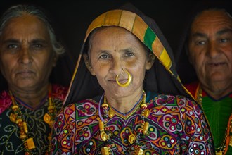Elderly Ahir woman in traditional colorful clothes with a nose ring