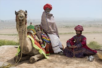 Men of the Rabari in traditional clothes with a dromedary