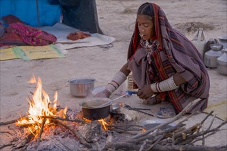 Fakirani woman cooking at a wood fire camp