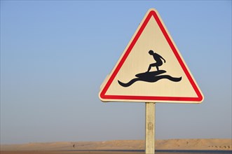 Road sign 'Caution Surfers' at the Rio de Oro Bay