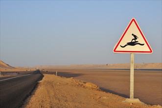 Road sign 'Caution Surfers' at the Rio de Oro Bay