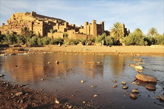 The Kasbah and the fortified city or ksar Ait Ben Haddou reflected in the Asif Mellah river