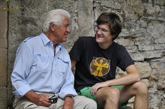 Grandfather and grandson in conversation