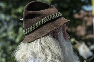 Old man with long gray hair and a traditional Bavarian hat