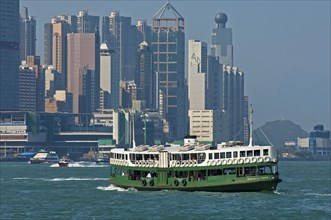 A ferry of the 'Star Ferry' shipping company crosses the basin of the Victoria Harbour