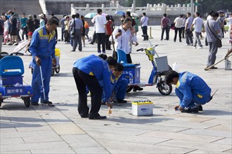 Workers removing chewing gum from Tiananmen Square