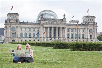 Two young women studying a map of Berlin