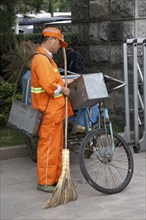 Street cleaner sleeping while standing