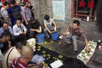 Walnut gamblers at the market of Tianjiao