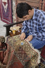 Man repairing a used carpet