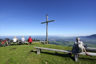 Hikers at the summit cross on Blomberg Mountain
