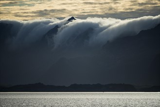 Clouds rolling over mountains