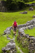 A man hiking along a Mulattiera near Sabbione