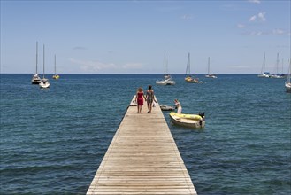 Two people walking on a jetty