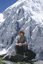 Mountaineer Reinhold Messner sitting in front of Mt Koenigsspitze