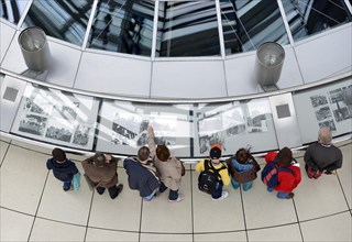 Visitors viewing an exhibition in the interior of the dome of the Reichstag Building