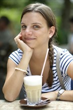 Young woman with a latte macchiato