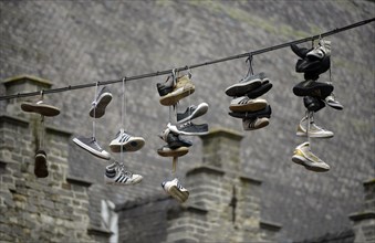 Shoes hanging on a rope between taverns