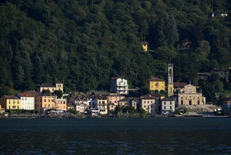 Village of Porto Ceresio with the Parish Church of Chiesa Sancto Ambrosio on Lake Lugano or Lago di Lugano