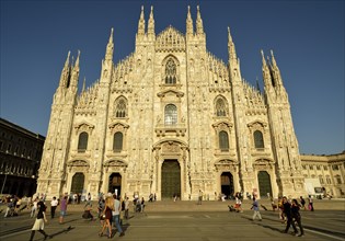 Tourists in front of the west facade of Milan Cathedral or Duomo di Santa Maria Nascente