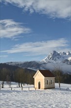 Small chapel in winter landscape