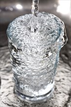Water overflowing in a glass
