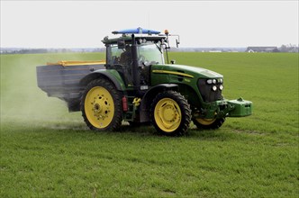 Fertilisation with a tractor on a green field