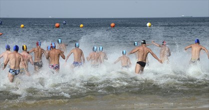 Men running into the sea