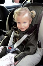 Girl in a car safety seat in a car