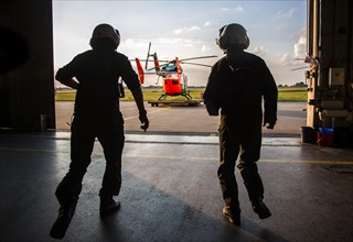 Pilots sprinting towards a helicopter