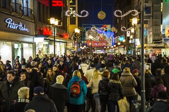 Crowds thronging between stores and Christmas market stalls