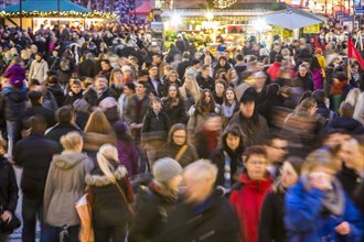 Crowds thronging between stores and Christmas market stalls