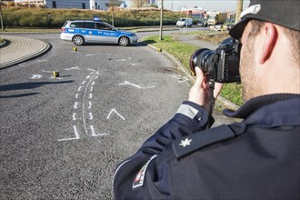 Policeman taking pictures on the scene of a traffic accident