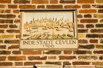 Plaque with a townscape from 1700 above an entrance