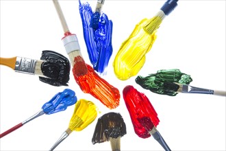 Different types of brushes with colourful acrylic paints